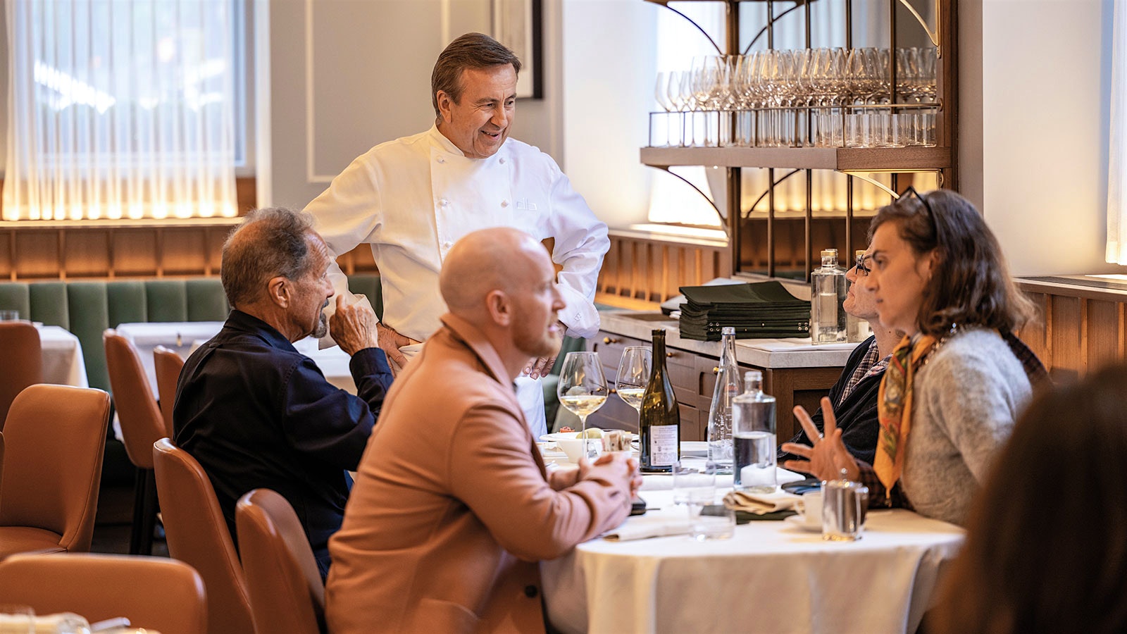 Chef Daniel Boulud talks with diners at Café Boulud in Manhattan